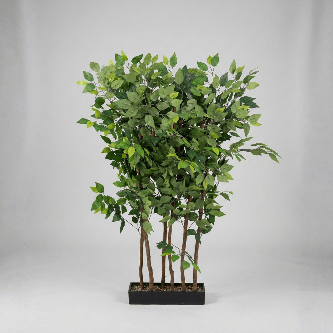 Artificial potted plant with green leaves on a gray background