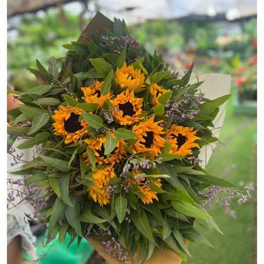 Bouquet of sunflowers and greenery in a garden setting