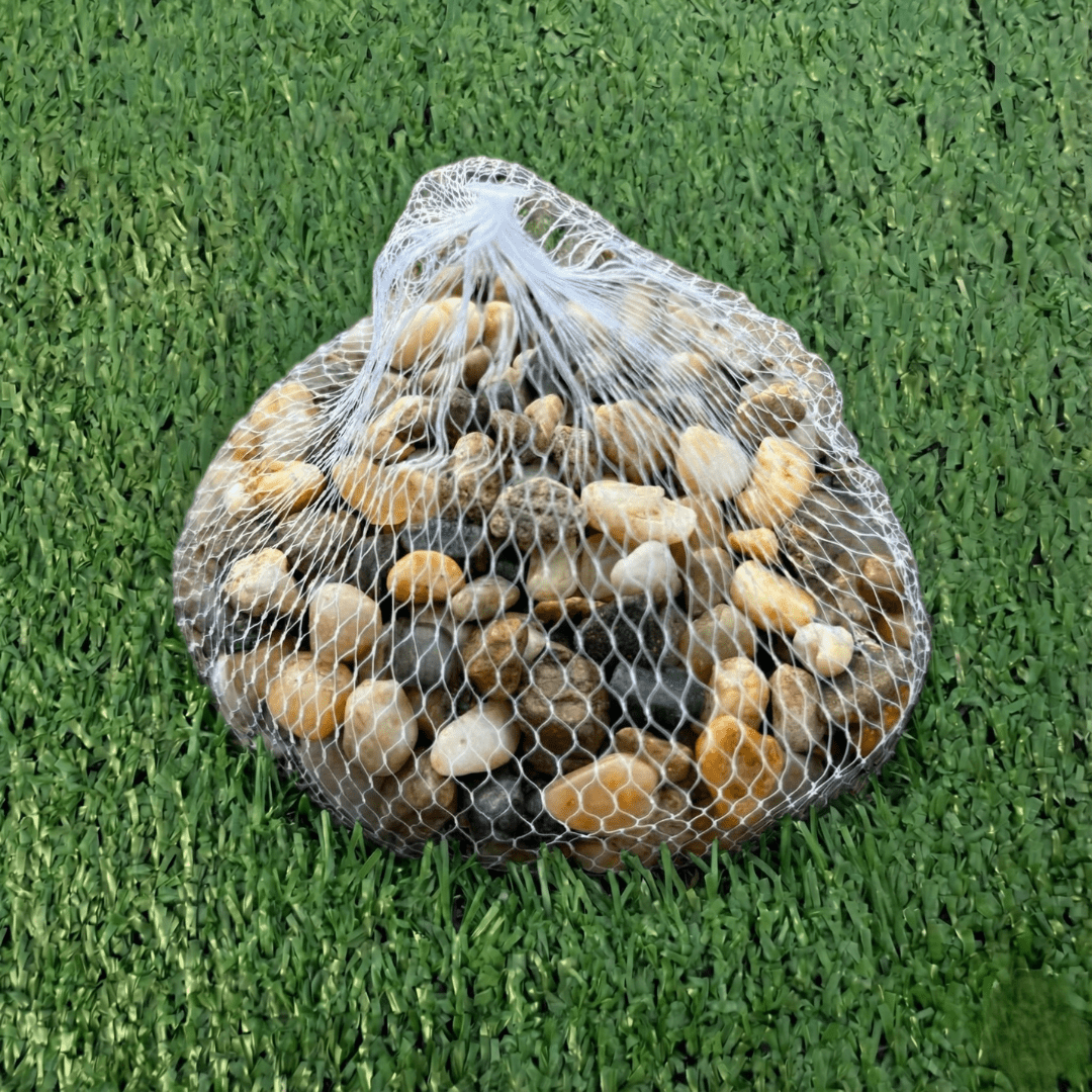 Bag of multicolored stones on a grassy background