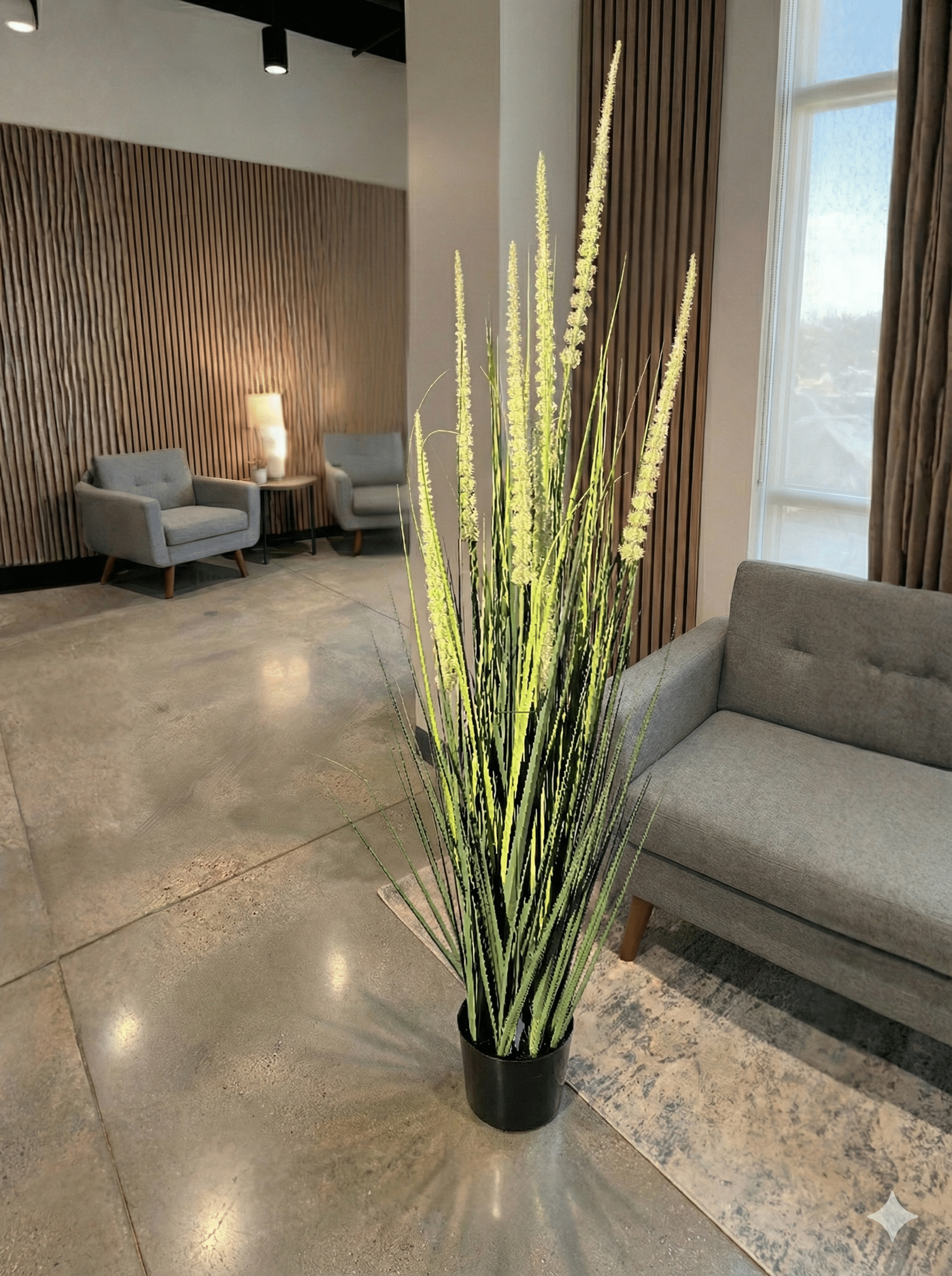 Decorative indoor artifical  plant in a pot on a polished floor with a modern interior setting.